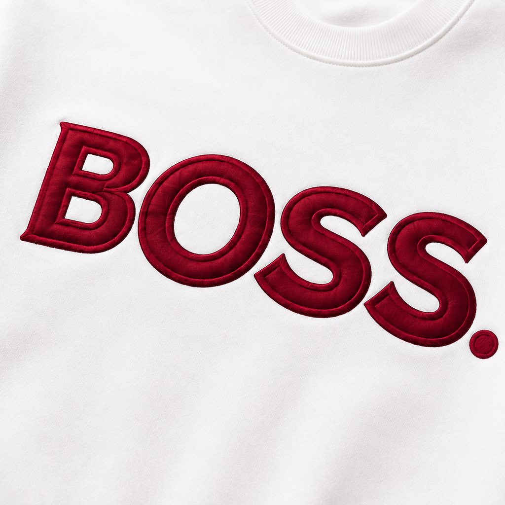 Close-up of burgundy BOSS satin applique and embroidered border