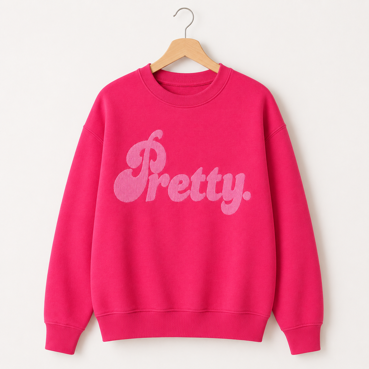 Bright pink Pretty embroidered crewneck sweatshirt on wooden hanger