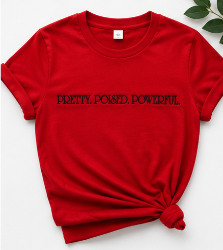 Red PRETTY POISED POWERFUL embroidered tee flat lay