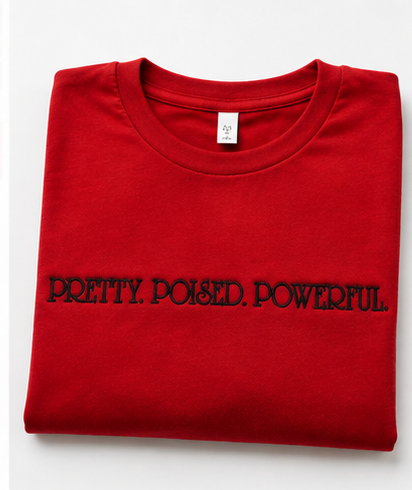 Folded red PRETTY POISED POWERFUL embroidered tee