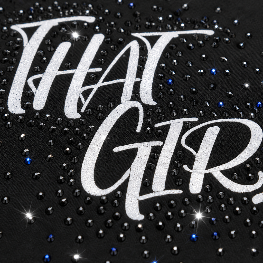 Close-up of THAT GIRL rhinestone embellishment and white script design