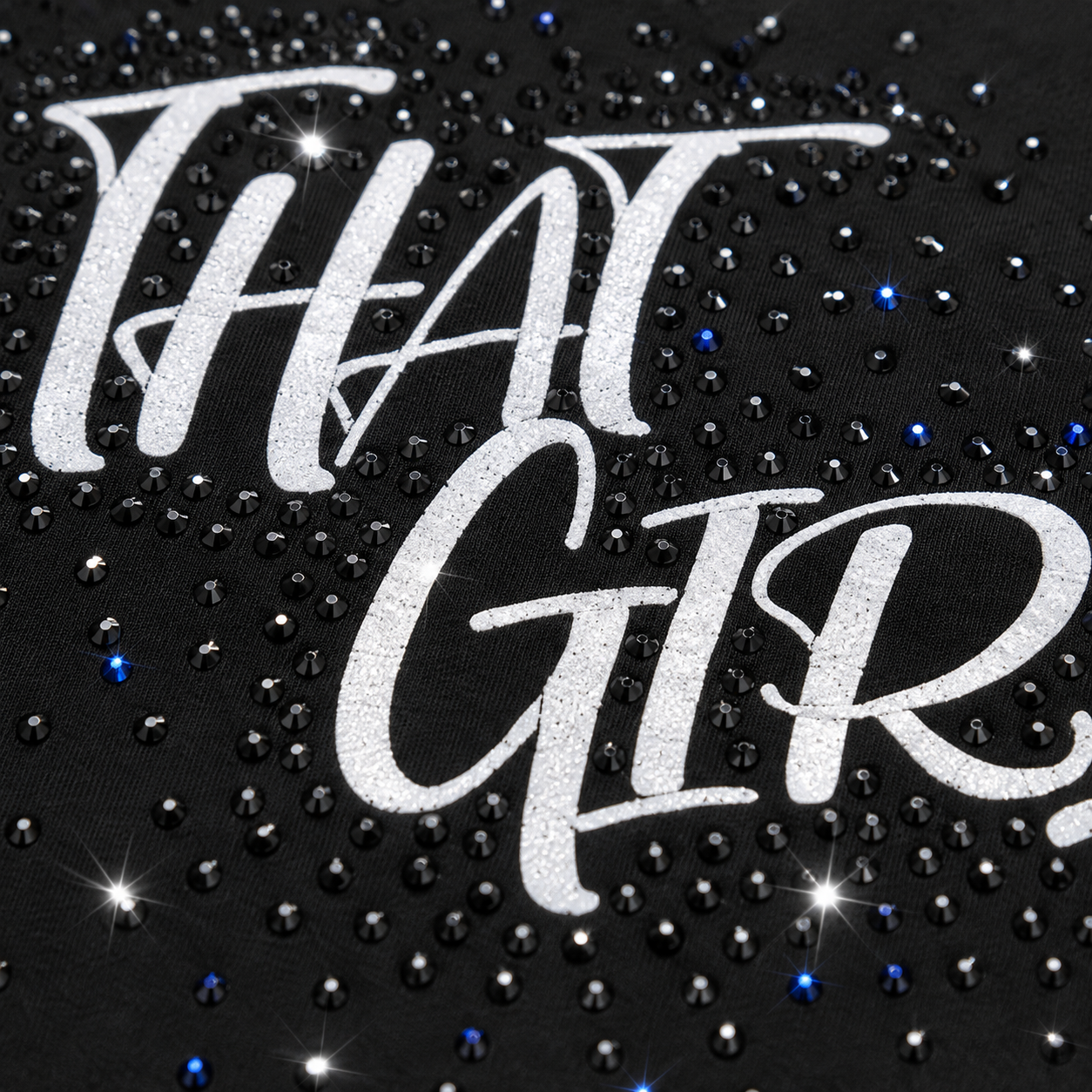 Close-up of THAT GIRL rhinestone embellishment and white script design